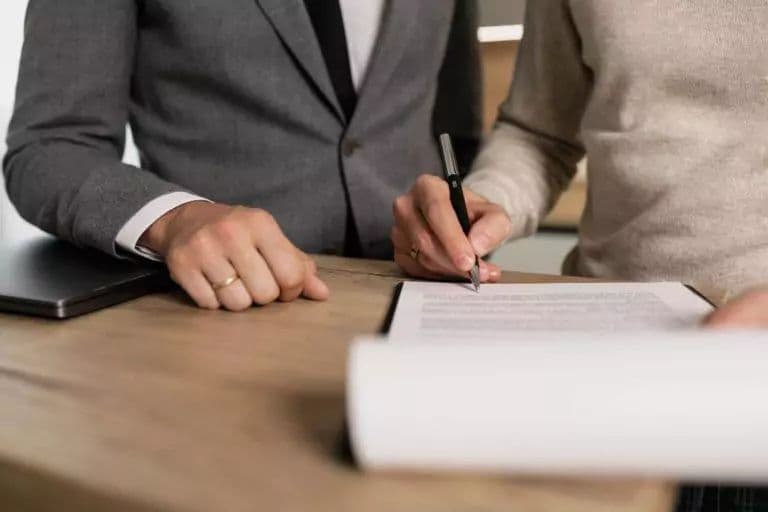 People signing a rental agreement at a desk