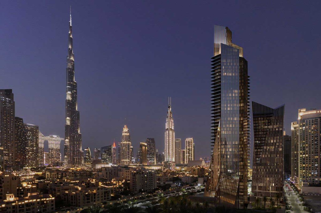 Low-angle view of modern curved towers framing a bright sky